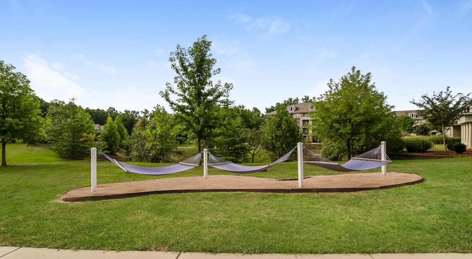 A beautiful community at the heart of all your passions a large green lawn with a white fence and trees