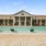 a large house with a pool in front of it