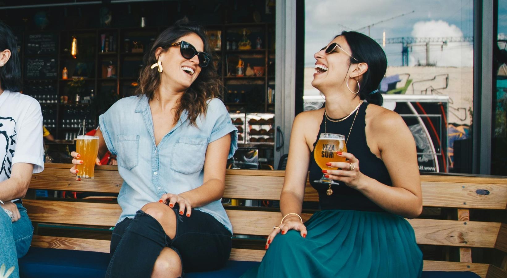 Bustling community with plenty of dining choices women sitting on a bench