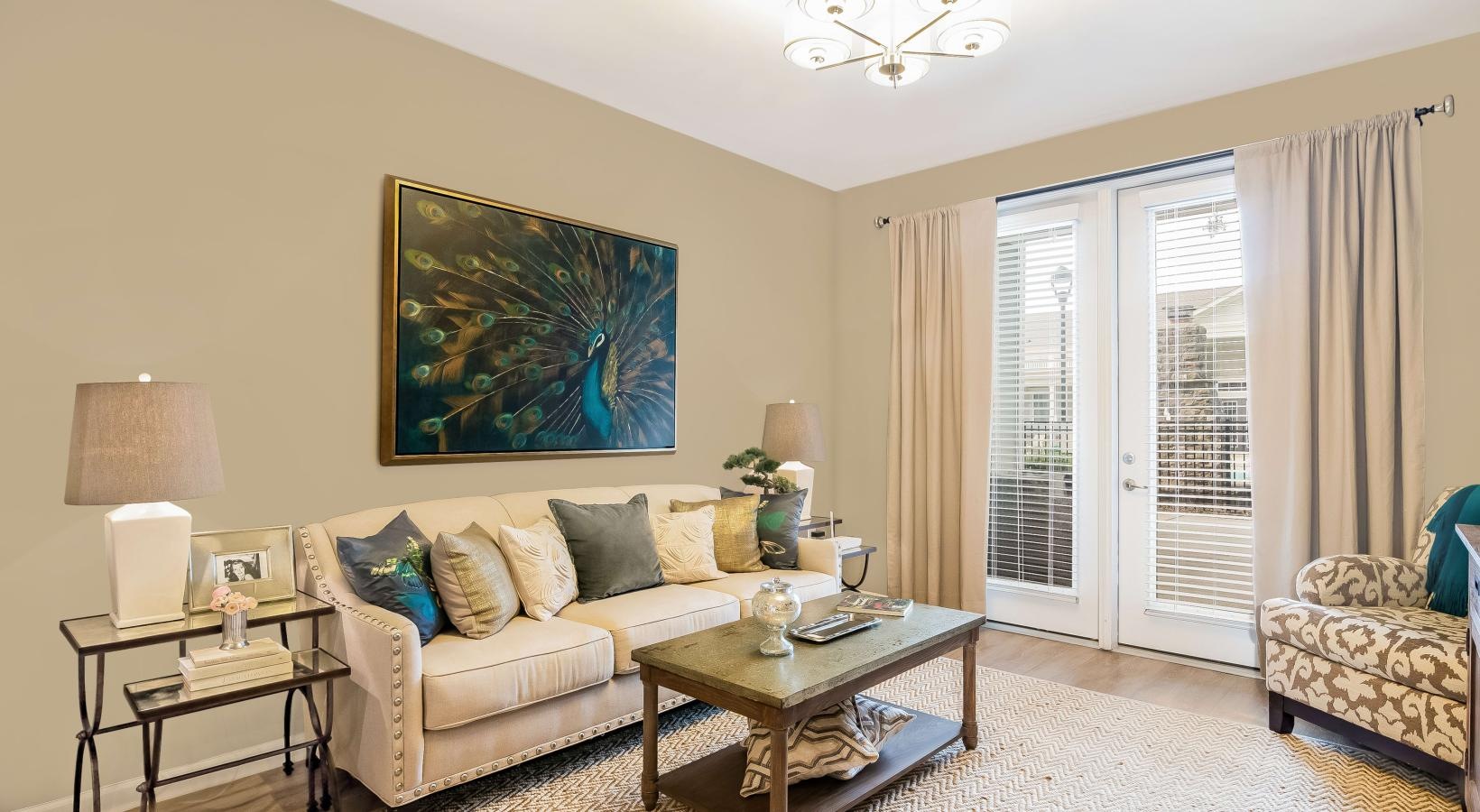 Generous living spaces with beautiful natural lighting a living room with a couch and a coffee table