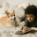 a boy reading a book to a dog