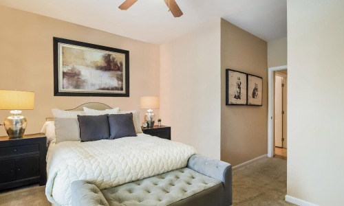 a bedroom with a bed and lamps