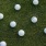 a group of white balls on grass