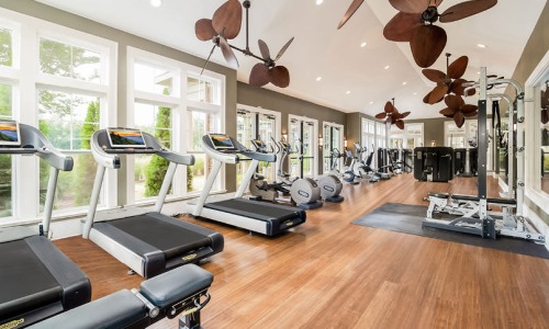 a room with exercise equipment and a large window