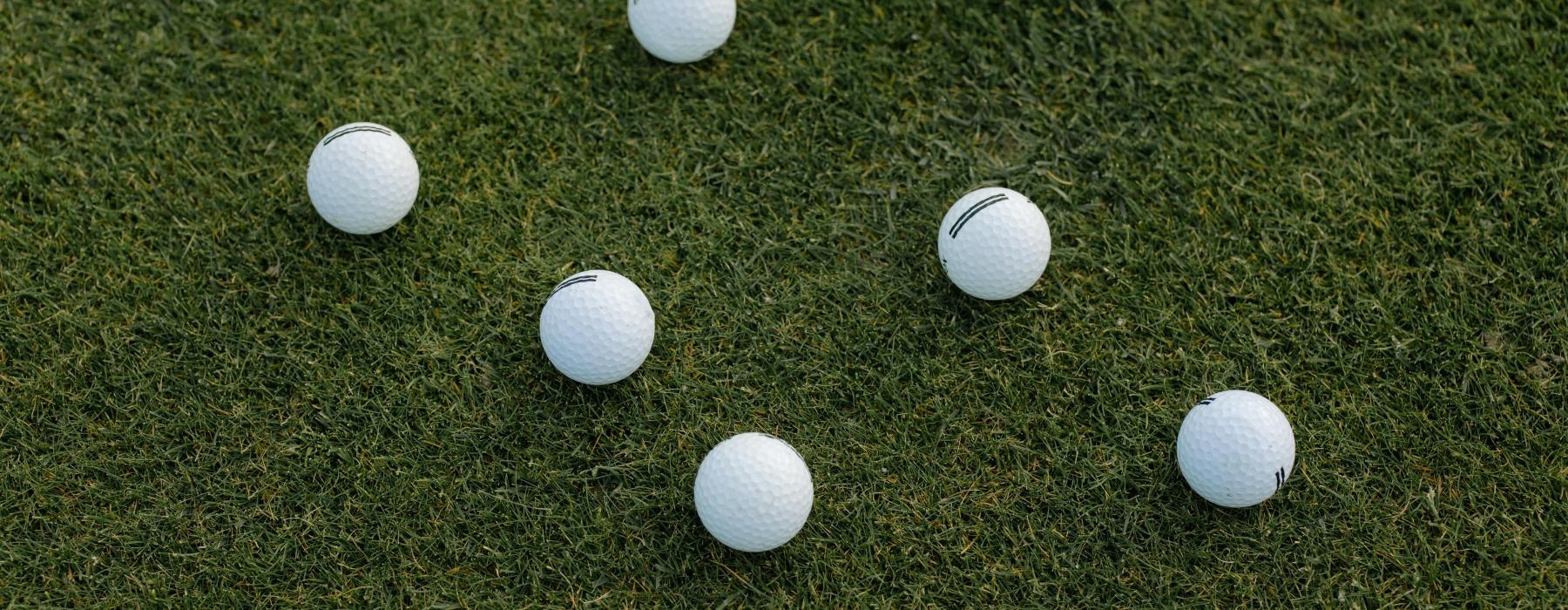 a group of white balls on grass
