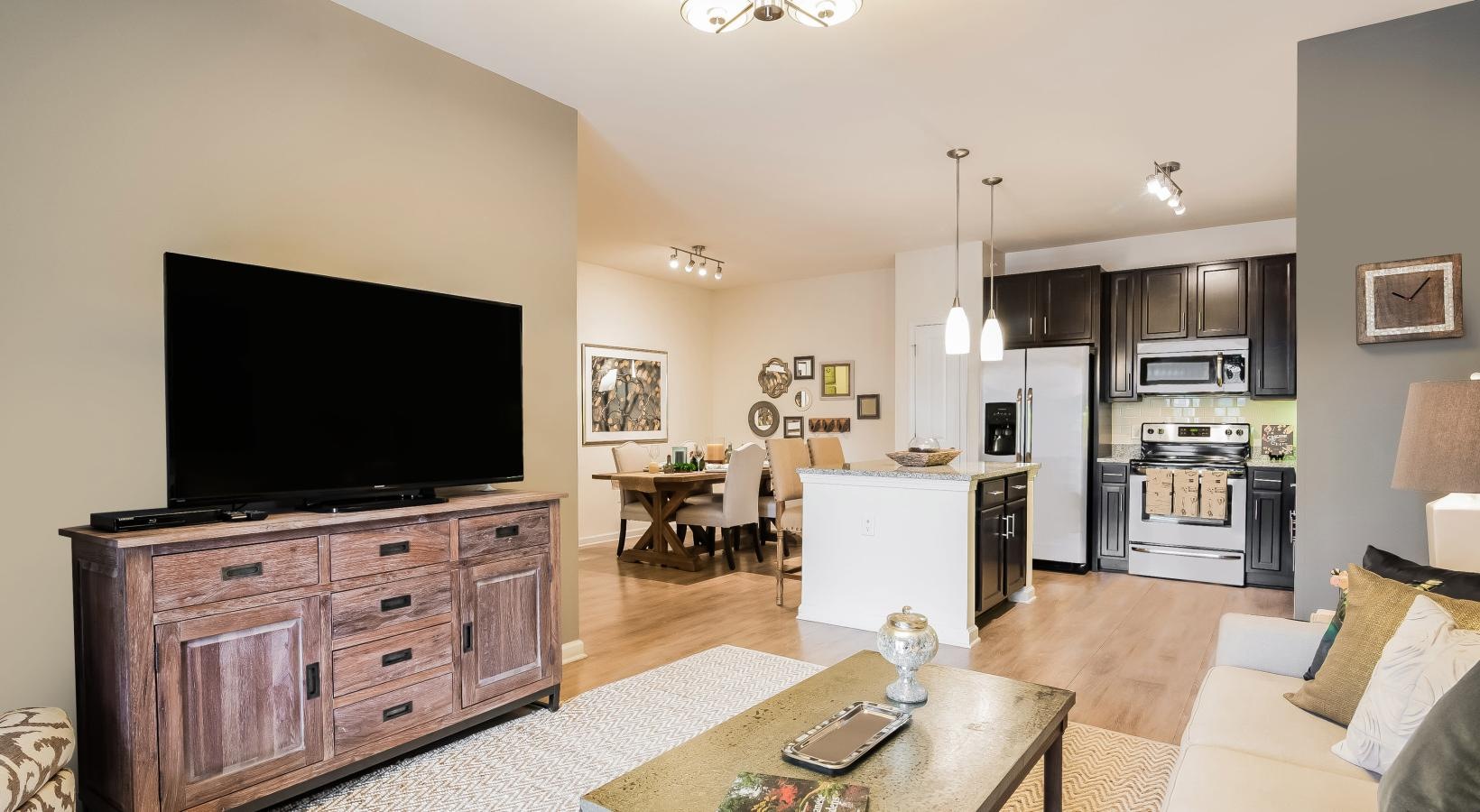 Generous living spaces to relax and unwind a living room with a tv and a table
