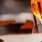 a glass of beer next to a plate of food