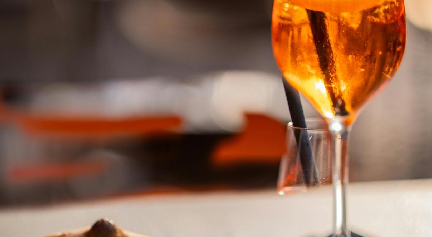 Vibrant community life with a variety of dining options a glass of beer next to a plate of food